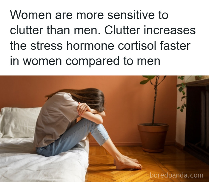 Woman sitting on bed, head resting on arms, illustrating psychology facts about stress and sensitivity to clutter.