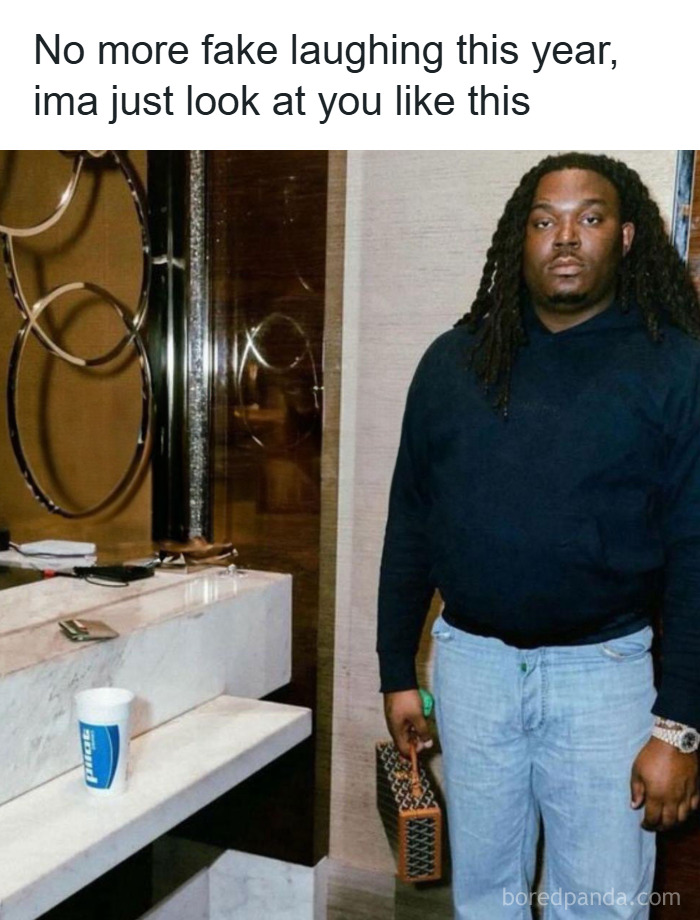 Man with long hair and serious expression holding a bag, epitomizing funny unhinged memes from Grapejuiceboys.