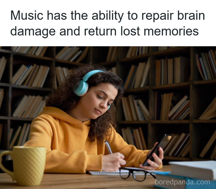 Young woman wearing headphones listens to music while writing notes, illustrating fun and fascinating psychology facts.