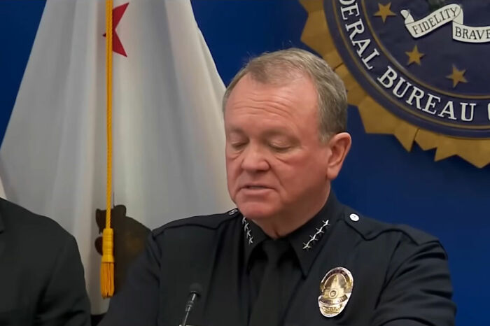 Police official in uniform at a press conference discussing new report on Nick Reiner's hotel room and arrest details Police official in uniform at a press conference discussing new report on Nick Reiner's hotel room and arrest details