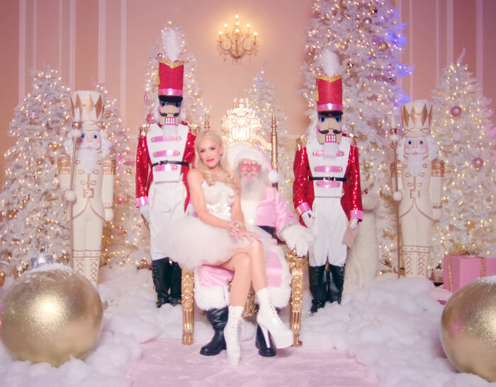 Gwen Stefani in a festive but controversial outfit at Rockefeller Tree Lighting with holiday decorations and nutcracker figures. Gwen Stefani in a festive but controversial outfit at Rockefeller Tree Lighting with holiday decorations and nutcracker figures.