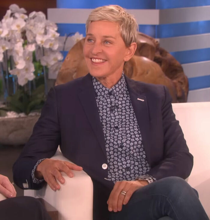 Comedian on a talk show set, smiling and wearing a patterned shirt and blazer, discussing banned stars from Tonight Show. Comedian on a talk show set, smiling and wearing a patterned shirt and blazer, discussing banned stars from Tonight Show.