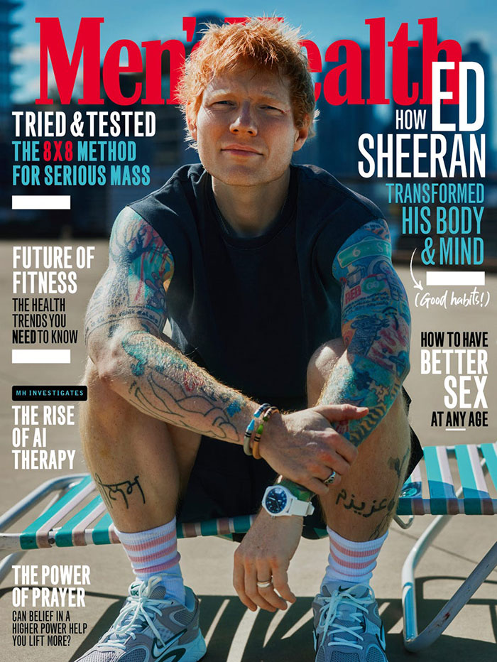 Ed Sheeran with shredded physique on Men's Health cover, showcasing tattoos and fitness transformation in bright outdoor setting.