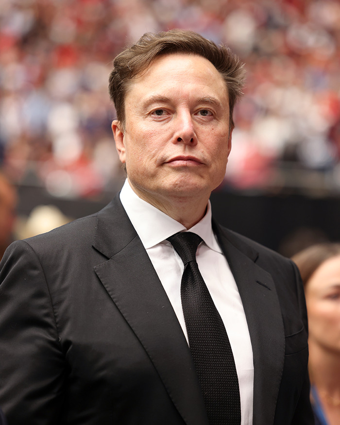 Elon Musk in a black suit and tie at a public event, linked to his comment sparking an online frenzy about Sydney Sweeney. Elon Musk in a black suit and tie at a public event, linked to his comment sparking an online frenzy about Sydney Sweeney.