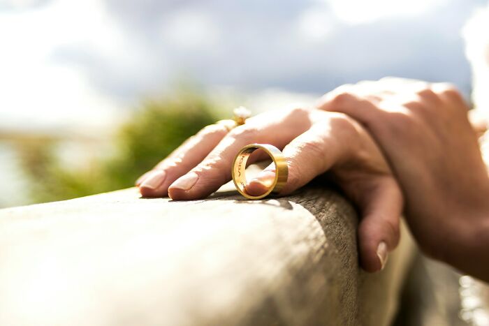 Close-up of hands with a wedding ring symbolizing dark secrets that change how people view relationships.