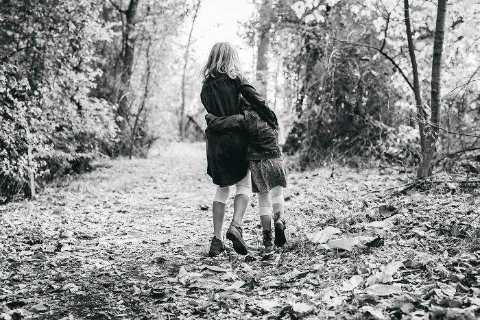 Two children walking through a forest path, reflecting a moment that could test your moral compass in challenging dilemmas.