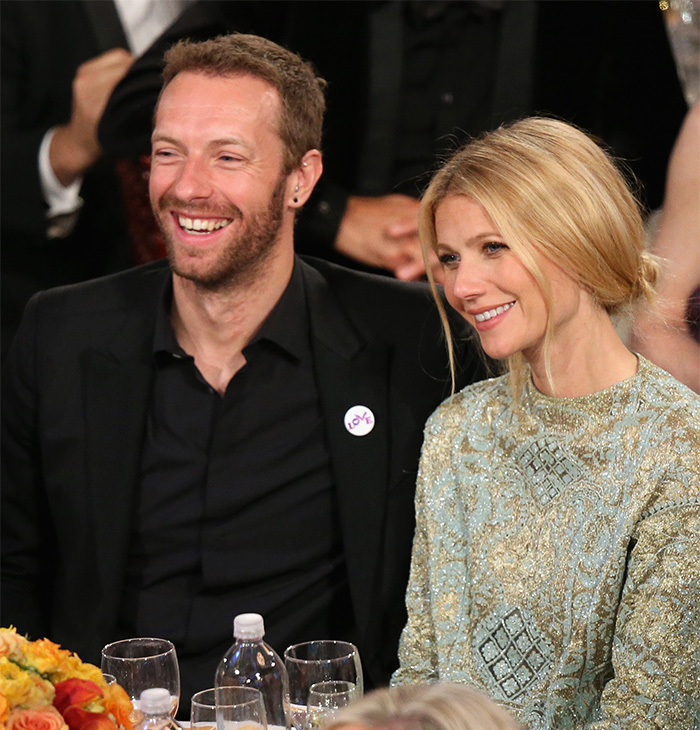 Coldplay members smiling at an event while an HR exec reacts to the Coldplay kiss cam moment.