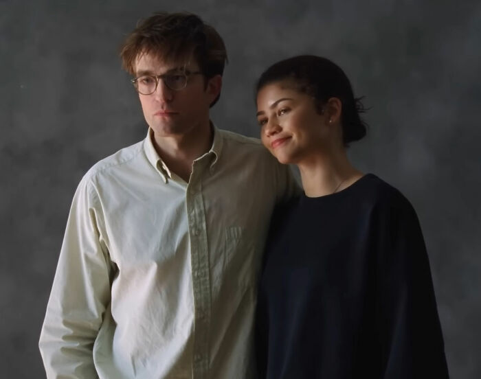 Robert Pattinson and Zendaya posing together in a promotional photo for their viral engagement ad campaign.