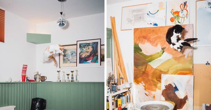 Two jumping cats captured mid-air in a colorful art studio filled with paintings and creative supplies.