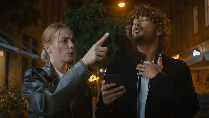 Girl upset and crying while roasting friend with insults during heated argument on city street at night Girl upset and crying while roasting friend with insults during heated argument on city street at night