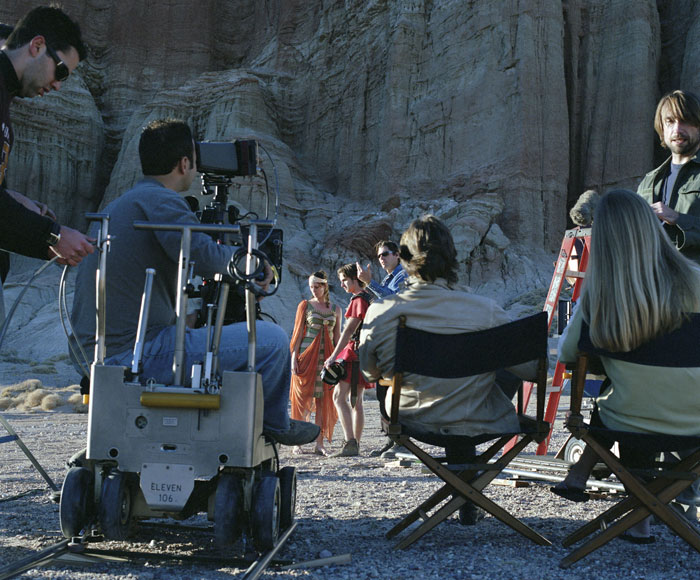 Film crew on location filming actors, highlighting writer collaboration to break into Hollywood industry success. Film crew on location filming actors, highlighting writer collaboration to break into Hollywood industry success.