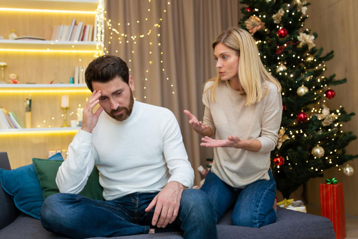 Couple arguing at home during Christmas, highlighting conflict over inviting random people to the house. Couple arguing at home during Christmas, highlighting conflict over inviting random people to the house.