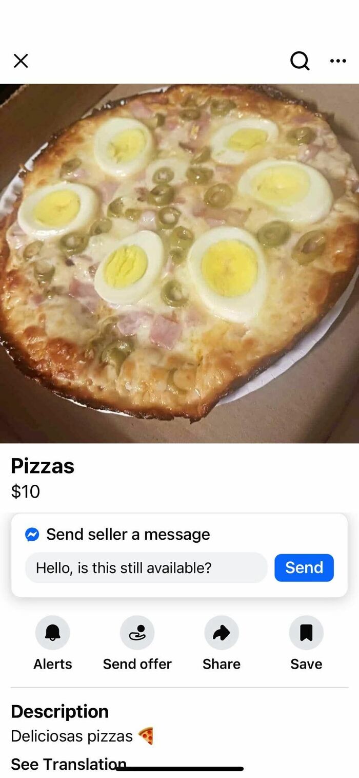 Pizza topped with hard-boiled egg slices and green olives in a poorly presented food pic for online shaming