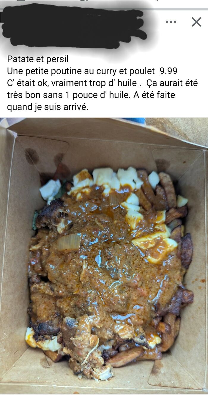 Overly oily curry chicken poutine with fries and cheese curds in a cardboard takeout container, food pics to be shamed online.