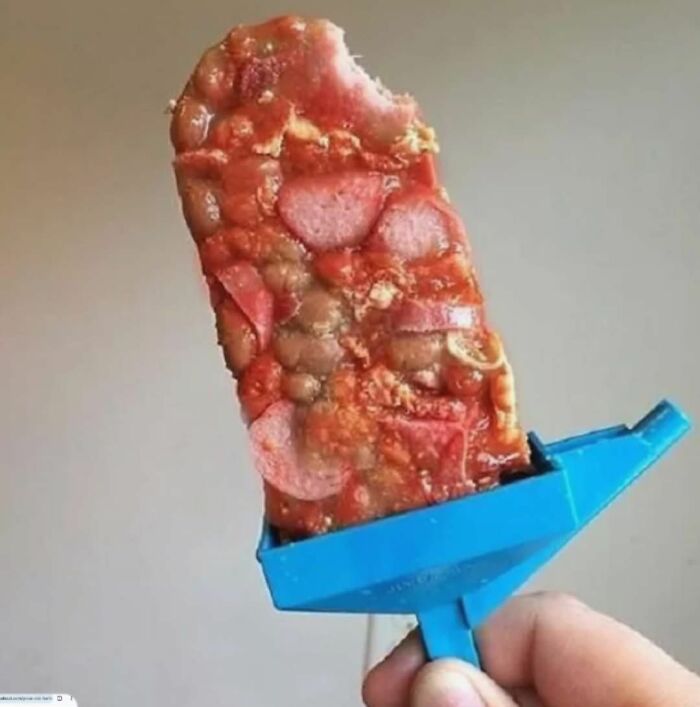 Frozen pizza popsicle held in hand, one of the food pics that deserve to be shamed online for odd presentation.