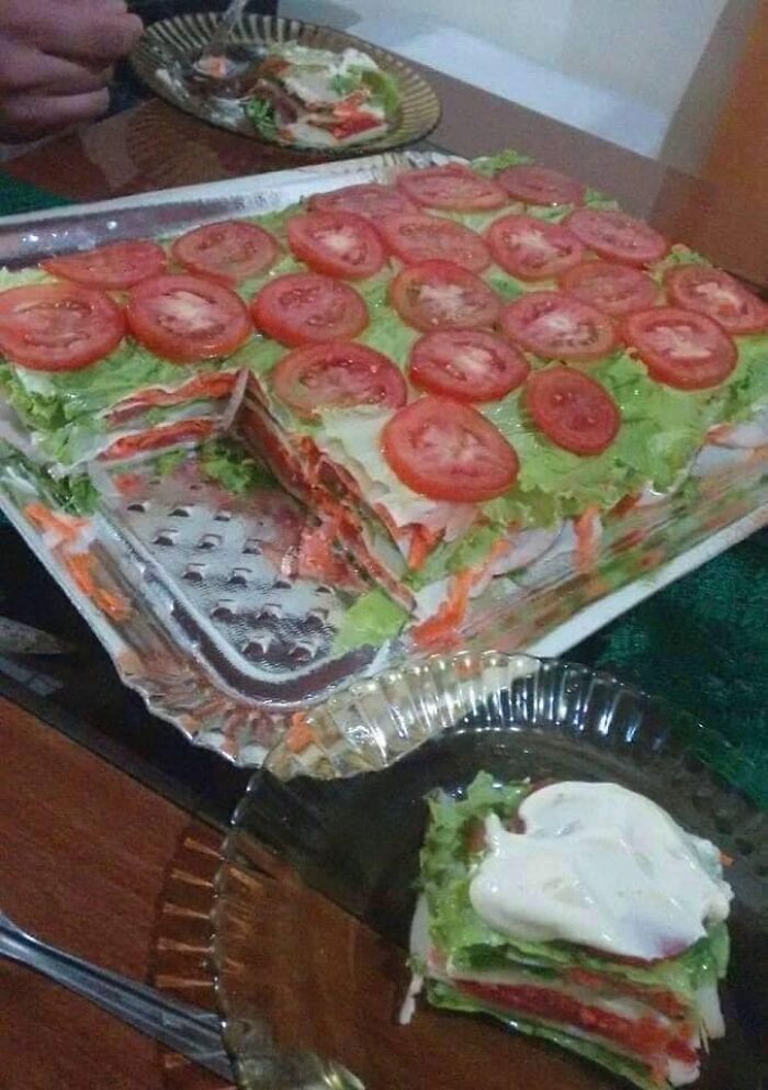 Layered vegetable dish with tomato slices and lettuce, an example of food pics that deserve to be shamed online.