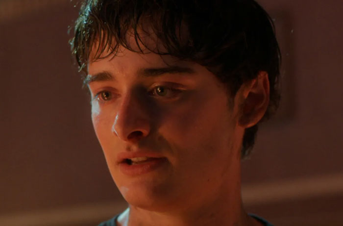 Close-up of a young man watching Stranger Things Season 5, capturing moments of parents' funniest reactions.