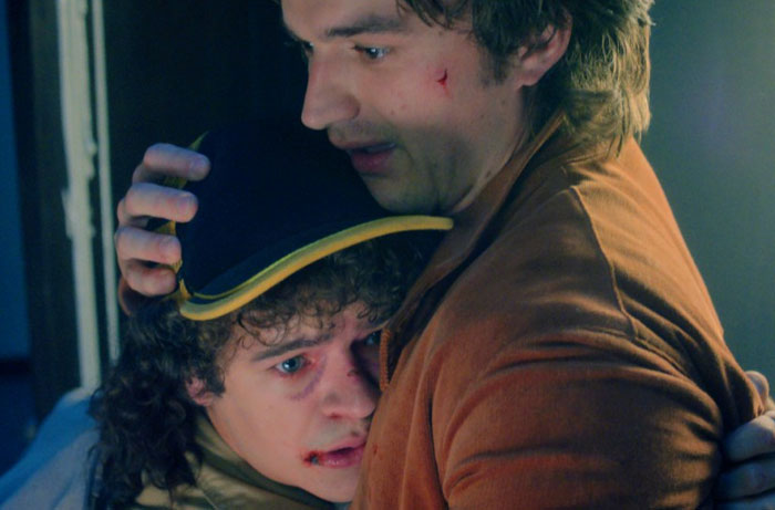 Two characters from Stranger Things season 5 share an emotional hug, highlighting memorable moments from the series.