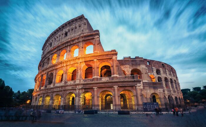 Ancient Colosseum in Rome illuminated at dusk with a dramatic cloudy sky, symbolizing crazy facts shared online. Ancient Colosseum in Rome illuminated at dusk with a dramatic cloudy sky, symbolizing crazy facts shared online.