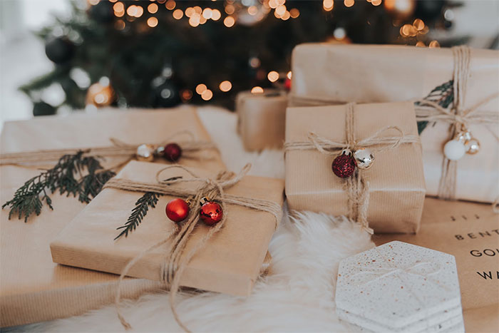 Christmas presents wrapped in brown paper with festive decorations, highlighting unthoughtful gift giving during the holiday season. Christmas presents wrapped in brown paper with festive decorations, highlighting unthoughtful gift giving during the holiday season.