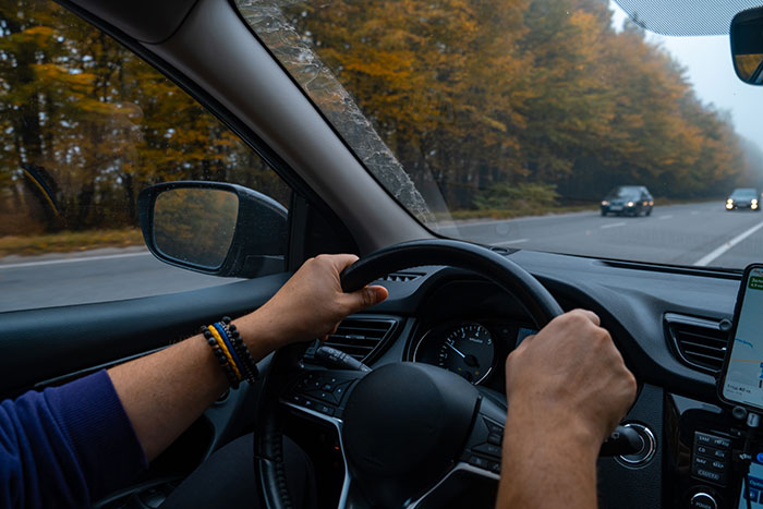 Man driving car on a scenic road, symbolizing a guy going above and beyond for his ex girlfriend. Man driving car on a scenic road, symbolizing a guy going above and beyond for his ex girlfriend.