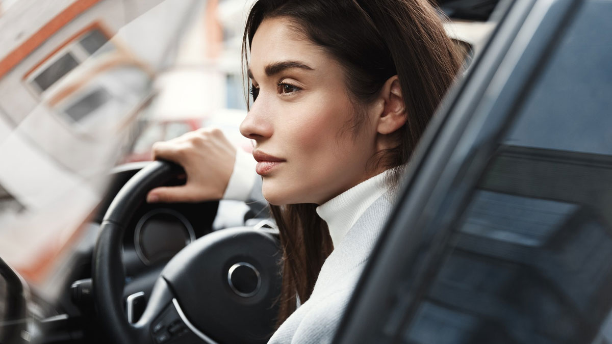 Woman waiting patiently in car, showing frustration with unpunctual friend casually painting her nails before event