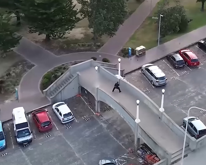 Police officer at Bondi Beach parking area captured from above, involved in a once-in-lifetime move stopping attacker.