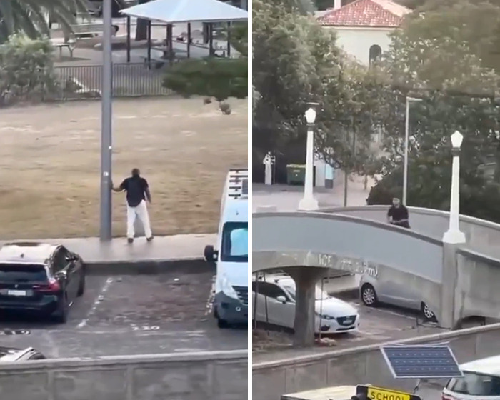 Man wearing dark shirt and light pants standing near a pole and walking on a bridge, related to Bondi Beach attacker hero cop.