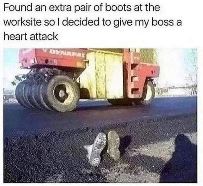 Pair of boots placed under large road roller machine as a funny meme for dark and cold winter days.