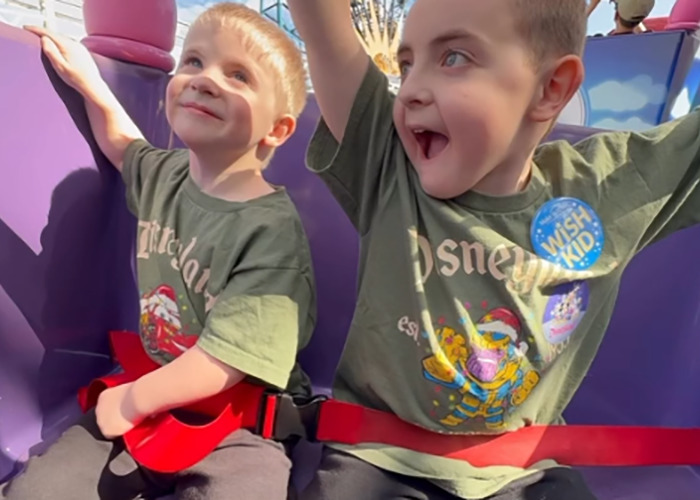 Two young boys wearing matching Disney shirts enjoying a ride, linked to terminally ill kids and Hilary Swank apology news. Two young boys wearing matching Disney shirts enjoying a ride, linked to terminally ill kids and Hilary Swank apology news.