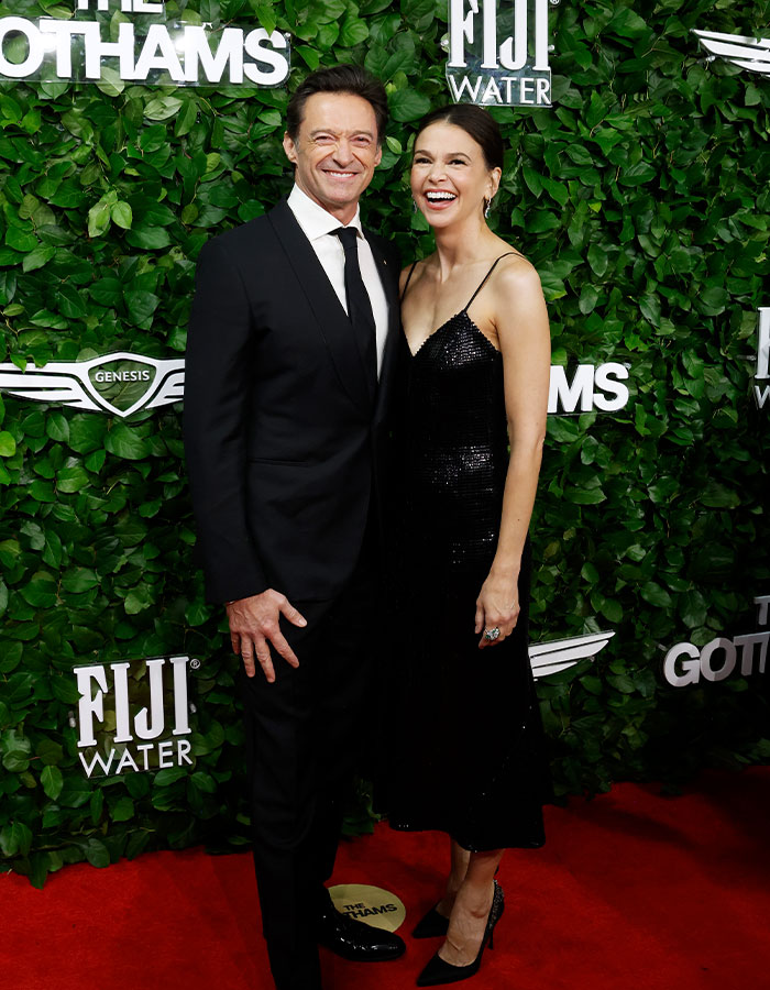 Hugh Jackman and Sutton Foster smiling together on red carpet amid divorce controversy and new girlfriend rumors.