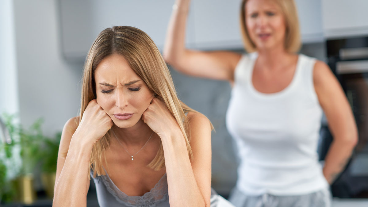 Wife frustrated and husband wonu2019t stand up to his mother during tense argument in a modern kitchen setting.