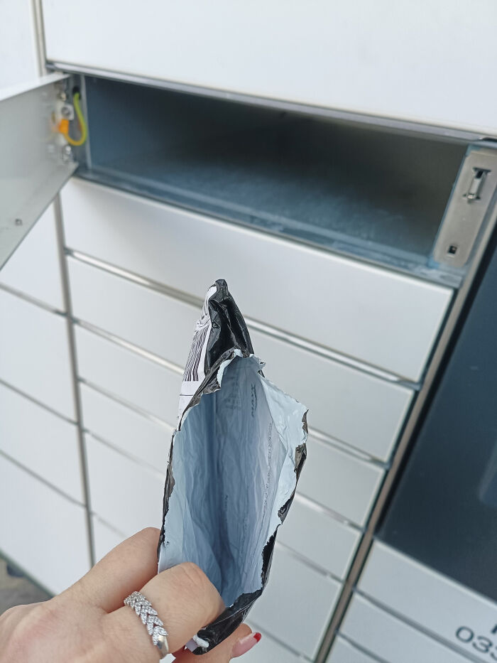 Empty Vinted package held in front of locker slot showing unhinged Vinted posts that surprise buyers.