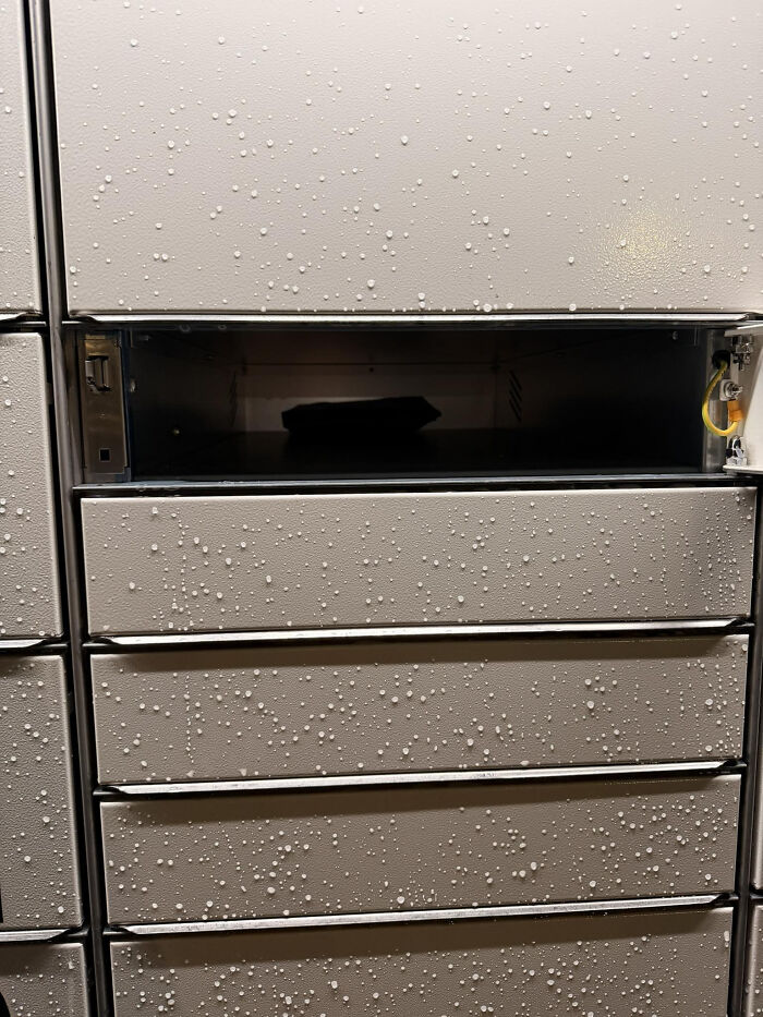 Close-up of mailbox with droplets on surface and one open compartment, illustrating unhinged Vinted posts moments.
