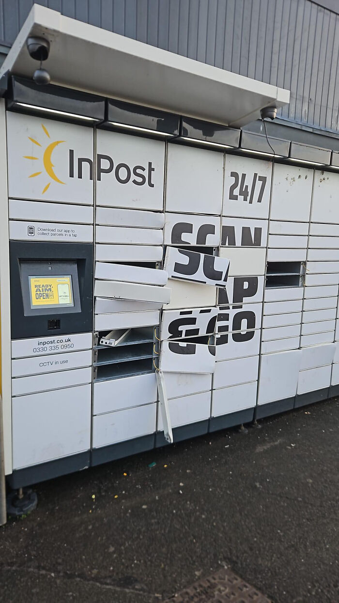 Damaged InPost delivery locker with broken doors and torn Scan & Go sign outdoors.