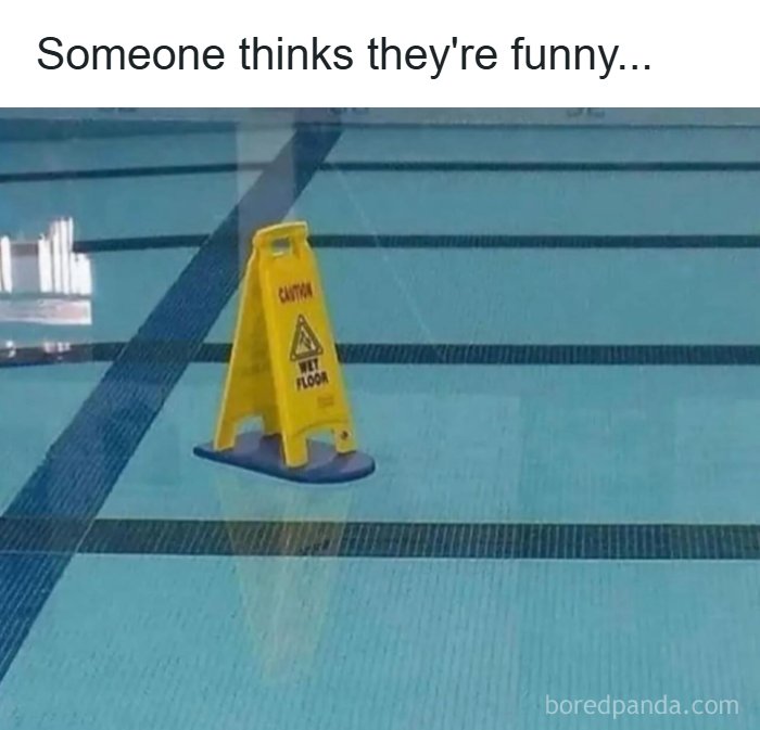 Yellow caution wet floor sign placed inside an empty swimming pool, illustrating a funny dad joke scene.