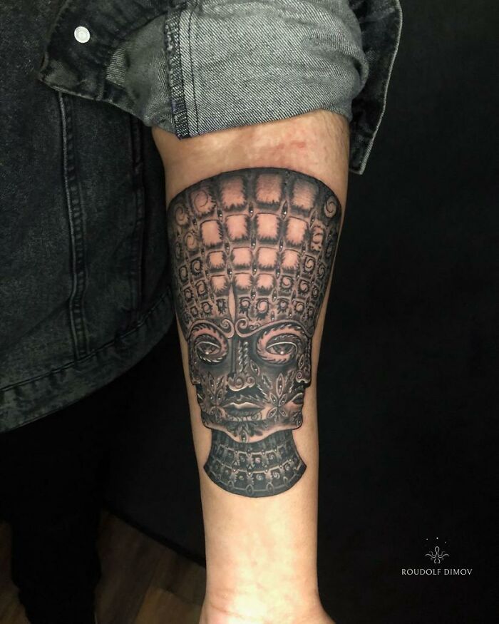 Intricate psychedelic tattoo on forearm featuring a detailed, surreal face design capturing attention and curiosity. Intricate psychedelic tattoo on forearm featuring a detailed, surreal face design capturing attention and curiosity.