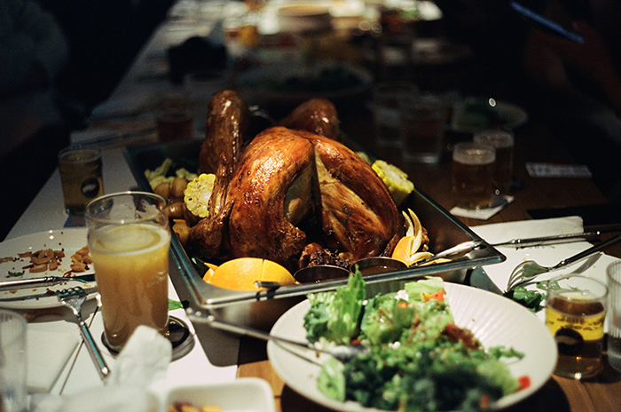 Roast turkey on a table surrounded by drinks and salad, capturing the moment of hunger and family gathering. Roast turkey on a table surrounded by drinks and salad, capturing the moment of hunger and family gathering.