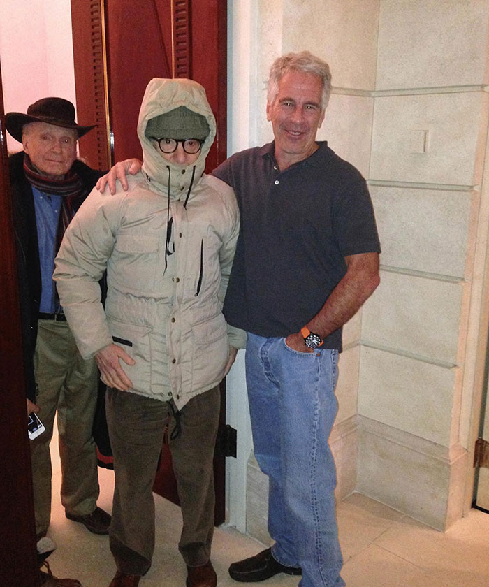 Epstein files reveal photos of men standing indoors, one in a hooded jacket, highlighting disturbing messages theme.