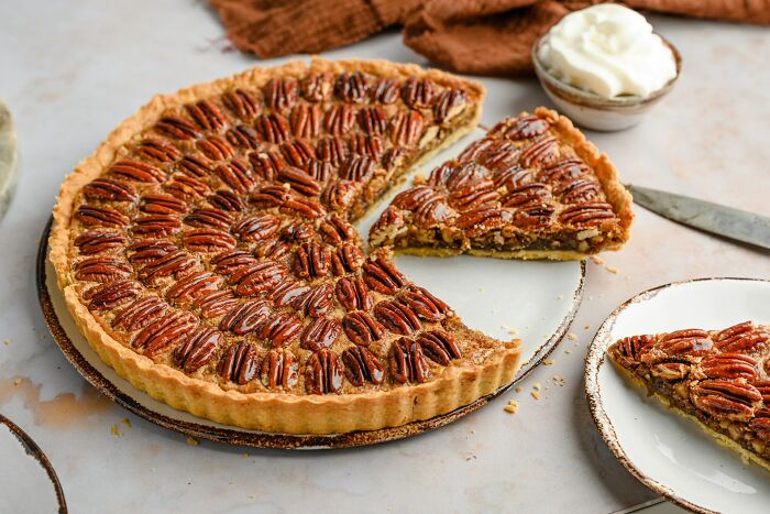 Pecan pie with a slice served on a plate, illustrating surprising secrets people trust strangers online with.