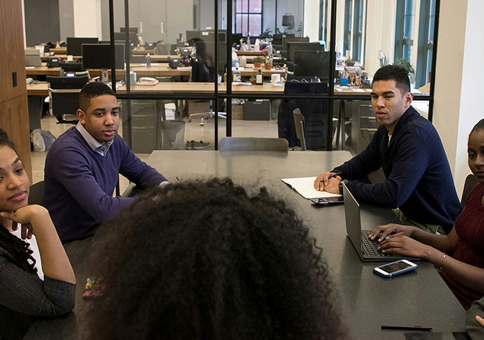 Group of diverse job candidates in a modern office engaged in a meeting with recruiters, asking mental questions.