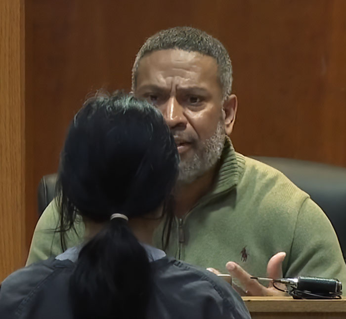 Judge speaking seriously to a teen in court during a harsh lesson after pepper-spraying tourists on a boat incident