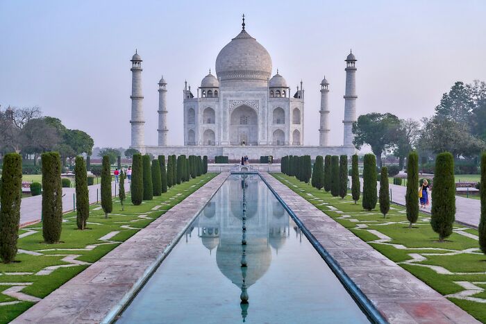 The Taj Mahal with visitors during sunset, as people share historical facts unknown until recently at the landmark site.