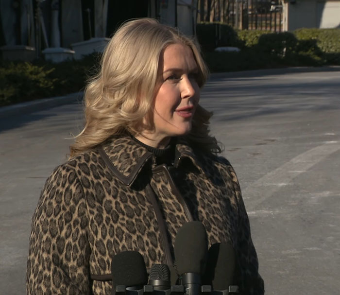 Karoline Leavitt speaking outdoors in a leopard print coat with microphones, VF photographer defends close-up amid mockery. Karoline Leavitt speaking outdoors in a leopard print coat with microphones, VF photographer defends close-up amid mockery.