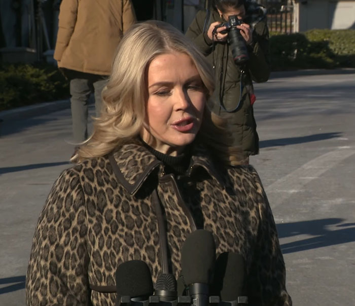 Karoline Leavitt speaking outside, with microphones and a photographer capturing her close-up defended by VF photographer. Karoline Leavitt speaking outside, with microphones and a photographer capturing her close-up defended by VF photographer.