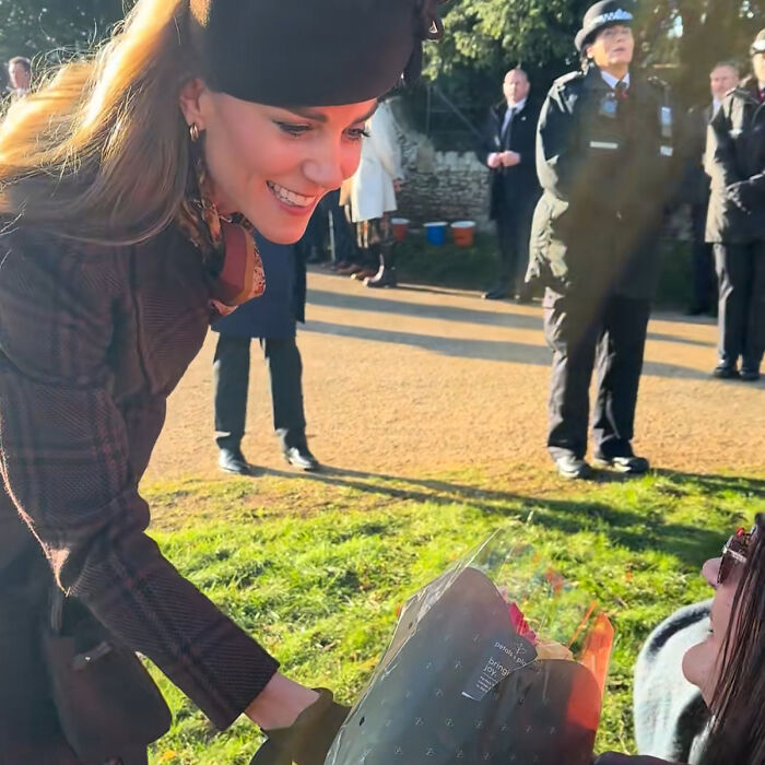 Kate Middleton smiling outdoors, showing a subtle facial scar, sparking 2024 hospitalization rumors and public speculation.