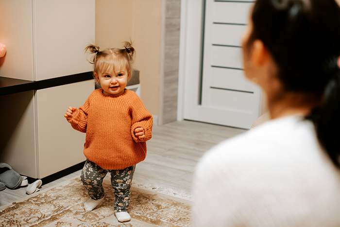 Toddler learning to walk at home with mama, a loving mother teaching and encouraging her child’s first steps. Toddler learning to walk at home with mama, a loving mother teaching and encouraging her child’s first steps.
