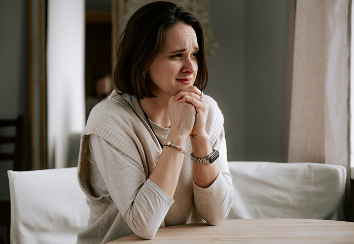 Young woman looking upset and thoughtful indoors, reflecting on immature guy and friends testing his new girlfriend.