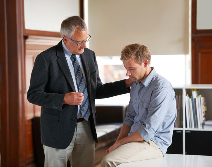 Older man offering support to a younger man, discussing kids custody and relationship challenges around a birthday event. Older man offering support to a younger man, discussing kids custody and relationship challenges around a birthday event.