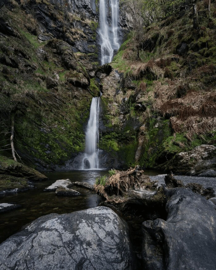 Waterfall cascading down moss-covered rocks in one of the places from around the world that look AI generated but are real.